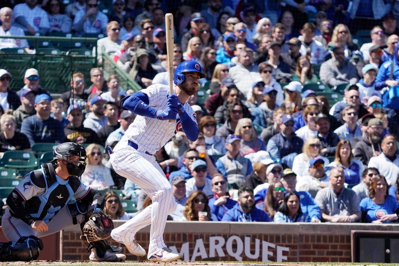 Apr 19, 2024; Chicago, Illinois, USA; Chicago Cubs outfielder Cody Bellinger (24) hits a RBI single against the Miami Marlins during the first inning at Wrigley Field. Mandatory Credit: David Banks-USA TODAY Sports