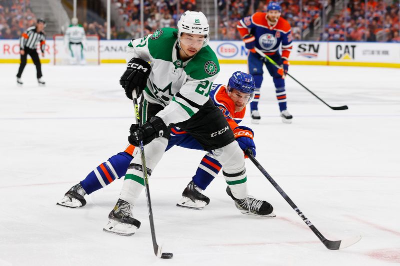 May 29, 2024; Edmonton, Alberta, CAN;   Dallas Stars forward Jason Robertson (21) protects the puck from Edmonton Oilers forward Ryan McLeod (71) during the second period in game four of the Western Conference Final of the 2024 Stanley Cup Playoffs at Rogers Place. Mandatory Credit: Perry Nelson-USA TODAY Sports