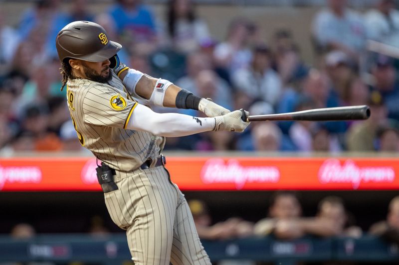 May 10, 2023; Minneapolis, Minnesota, USA; San Diego Padres right fielder Fernando Tatis Jr. (23) hits a single in the eighth inning against the Minnesota Twins at Target Field. Mandatory Credit: Jesse Johnson-USA TODAY Sports