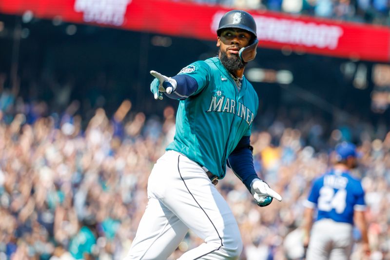 Aug 28, 2023; Seattle, Washington, USA; Seattle Mariners right fielder Teoscar Hernandez (35) points to the dugout after hitting a grand slam home run against the Kansas City Royals during the third inning at T-Mobile Park. Mandatory Credit: Joe Nicholson-USA TODAY Sports