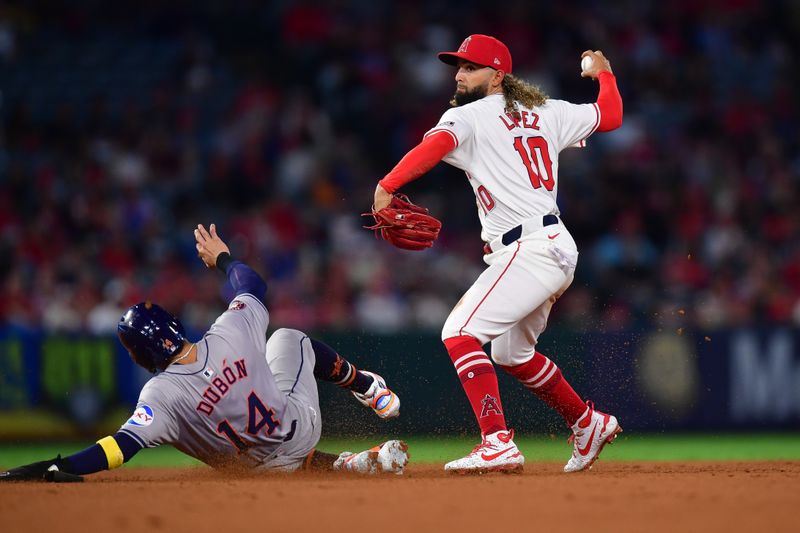 Sep 13, 2024; Anaheim, California, USA; Houston Astros left fielder Mauricio Dubón (14) is out at second as Los Angeles Angels second baseman Jack Lopez (10) throws to first for the out against second baseman Jose Altuve (27) during the eighth inning at Angel Stadium. Mandatory Credit: Gary A. Vasquez-Imagn Images