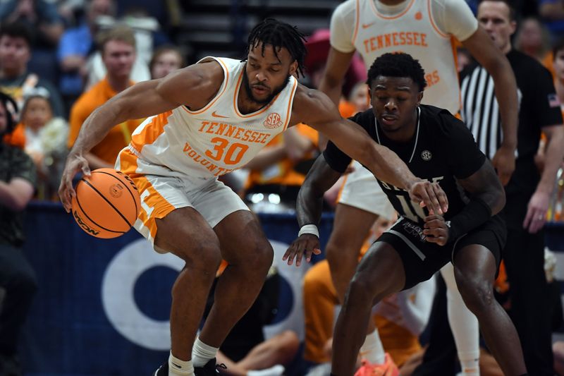 Mar 15, 2024; Nashville, TN, USA; Tennessee Volunteers guard Josiah-Jordan James (30) handles the ball against Mississippi State Bulldogs guard Dashawn Davis (10) during the second half at Bridgestone Arena. Mandatory Credit: Christopher Hanewinckel-USA TODAY Sports