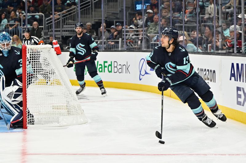 Sep 26, 2022; Seattle, Washington, USA; Seattle Kraken left wing Brandon Tanev (13) advances the puck against the Edmonton Oilers during the third period at Climate Pledge Arena. Mandatory Credit: Steven Bisig-USA TODAY Sports