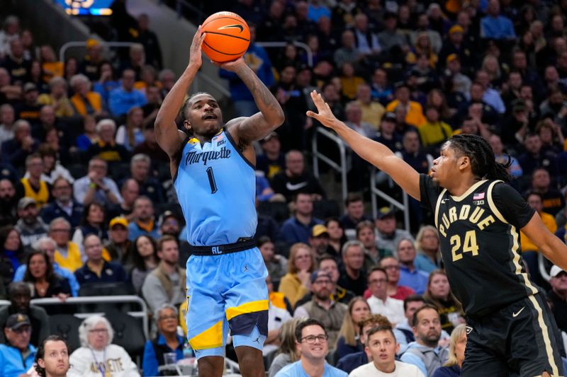 Nov 19, 2024; Milwaukee, Wisconsin, USA;  Marquette Golden Eagles guard Kam Jones (1) shoots against Purdue Boilermakers guard Gicarri Harris (24) during the second half at Fiserv Forum. Mandatory Credit: Jeff Hanisch-Imagn Images