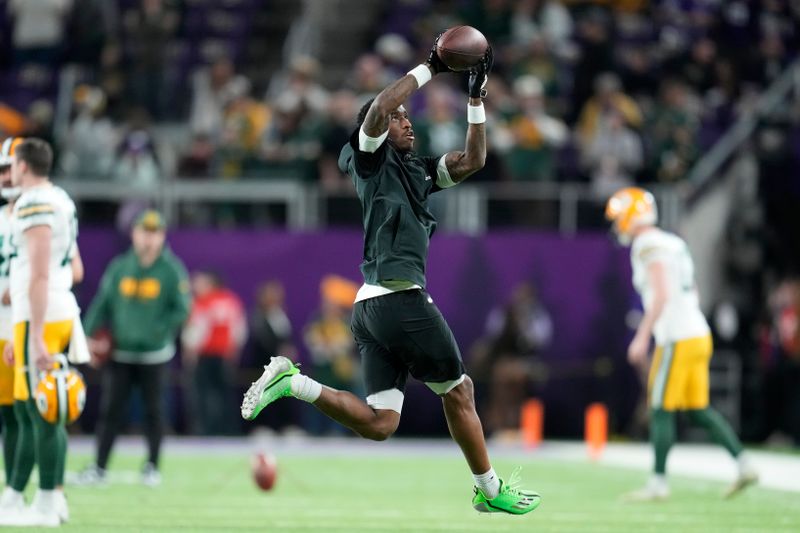 Minnesota Vikings' Jordan Addison warms up before an NFL football game against the Green Bay Packers Sunday, Dec. 31, 2023, in Minneapolis. (AP Photo/Abbie Parr)