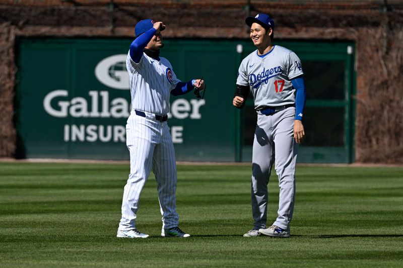 Apr 6, 2024; Chicago, Illinois, USA;  Chicago Cubs outfielder Seiya Suzuki (27) and Los Angeles Dodgers two-way player Shohei Ohtani (17) talk before their teams game at Wrigley Field. Mandatory Credit: Matt Marton-USA TODAY Sports