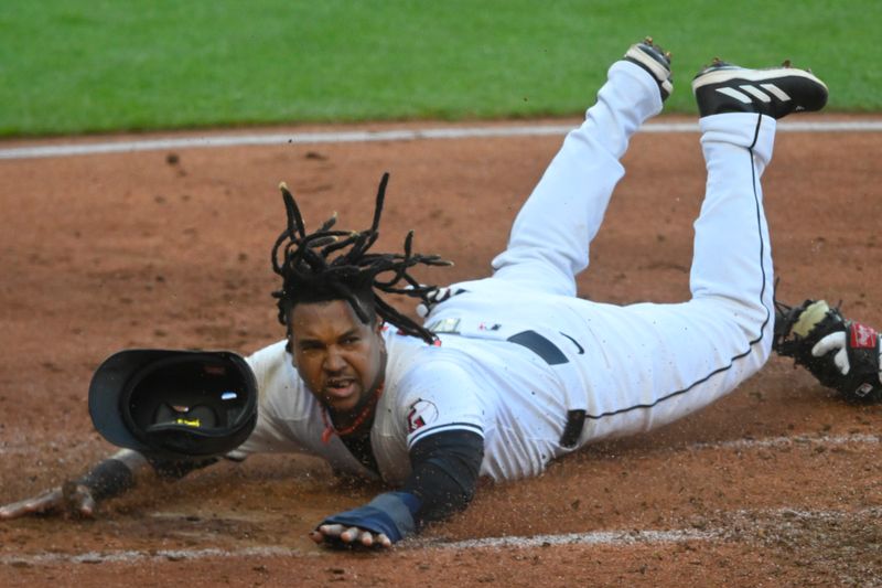 May 18, 2024; Cleveland, Ohio, USA; Cleveland Guardians third baseman Jose Ramirez (11) slides to home plate before being tagged out by Minnesota Twins catcher Christian Vazquez (8) in the third inning at Progressive Field. Mandatory Credit: David Richard-USA TODAY Sports
