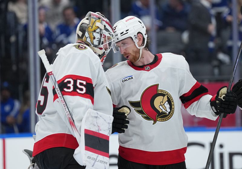 Apr 29, 2025; Toronto, Ontario, CAN; Ottawa Senators defenseman Jake Sanderson (85) celebrates with goaltender Linus Ullmark (35) after defeating the Toronto Maple Leafs during game five of the first round of the 2025 Stanley Cup Playoffs at Scotiabank Arena. Mandatory Credit: Nick Turchiaro-Imagn Images