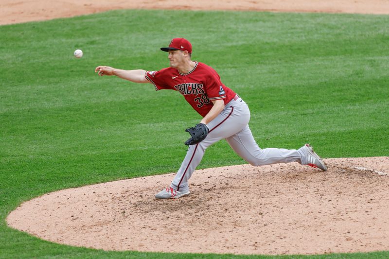 Sep 27, 2023; Chicago, Illinois, USA; Arizona Diamondbacks relief pitcher Paul Sewald (38) delivers a pitch against the Chicago White Sox during the ninth inning at Guaranteed Rate Field. Mandatory Credit: Kamil Krzaczynski-USA TODAY Sports