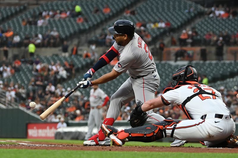 May 29, 2024; Baltimore, Maryland, USA;  Baltimore Orioles shortstop Gunnar Henderson (2) hits into a second inning fielders choice scoring catcher  Connor Wong (12) in the second inning  against the Baltimore Orioles at Oriole Park at Camden Yards. Mandatory Credit: Tommy Gilligan-USA TODAY Sports