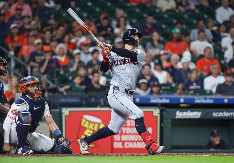 May 2, 2024; Houston, Texas, USA; Cleveland Guardians second baseman Andres Gimenez (0) hits an RBI double during the third inning against the Houston Astros at Minute Maid Park. Mandatory Credit: Troy Taormina-USA TODAY Sports