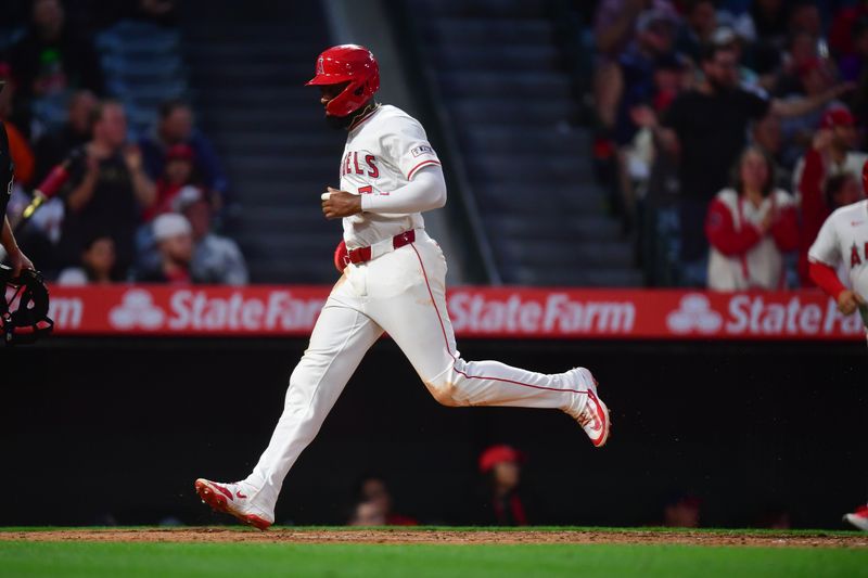 May 1, 2025; Anaheim, California, USA; Los Angeles Angels center fielder Jo Adell (7) scores a run against the Detroit Tigers during the fourth inning at Angel Stadium. Mandatory Credit: Gary A. Vasquez-Imagn Images