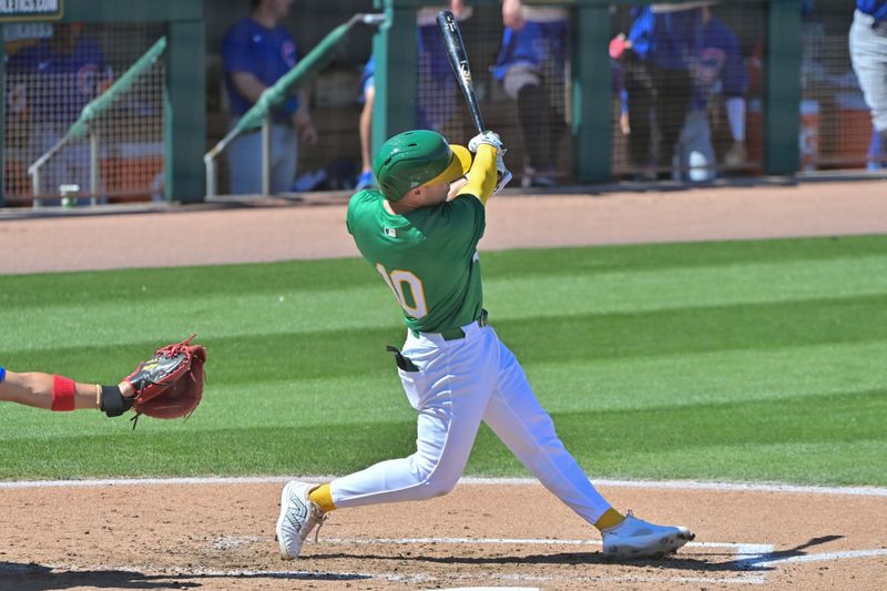 Mar 20, 2024; Mesa, Arizona, USA;  Oakland Athletics shortstop Nick Allen (10) hits a solo home run in the third inning against the Chicago Cubs during a spring training game at Hohokam Stadium. Mandatory Credit: Matt Kartozian-USA TODAY Sports