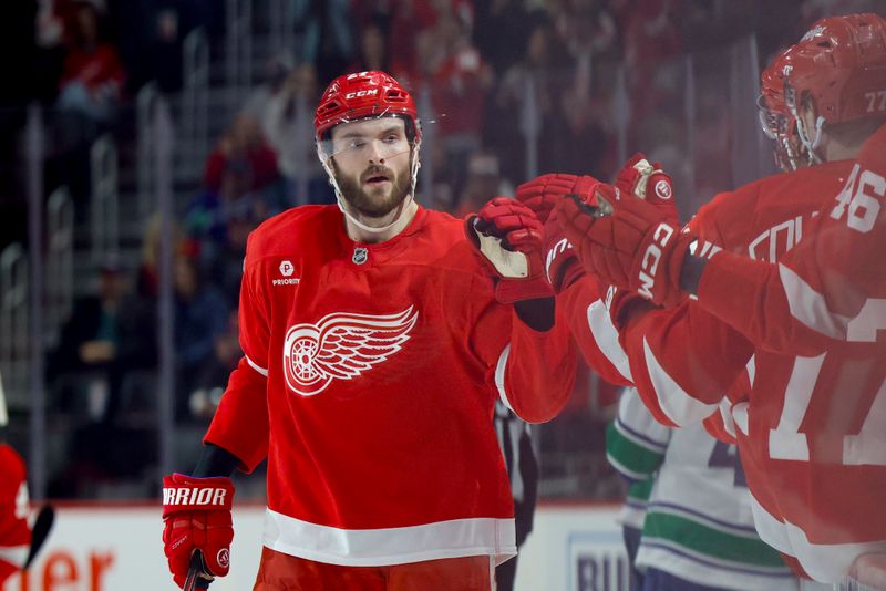 Dec 1, 2024; Detroit, Michigan, USA;  Detroit Red Wings center Michael Rasmussen (27) receives congratulations from teammates after scoring in the third period against the Vancouver Canucks at Little Caesars Arena. Mandatory Credit: Rick Osentoski-Imagn Images