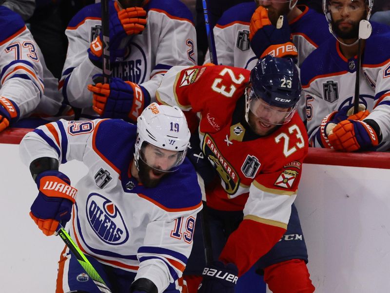 Jun 10, 2024; Sunrise, Florida, USA; Edmonton Oilers forward Adam Henrique (19) battles for the puck against Florida Panthers forward Carter Verhaeghe (23) during the first period in game two of the 2024 Stanley Cup Final at Amerant Bank Arena. Mandatory Credit: Sam Navarro-USA TODAY Sports