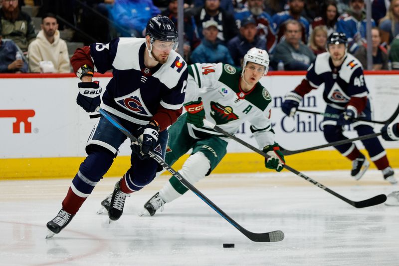 Apr 9, 2024; Denver, Colorado, USA; Colorado Avalanche right wing Valeri Nichushkin (13) controls the puck ahead of Minnesota Wild center Joel Eriksson Ek (14) in the first period at Ball Arena. Mandatory Credit: Isaiah J. Downing-USA TODAY Sports