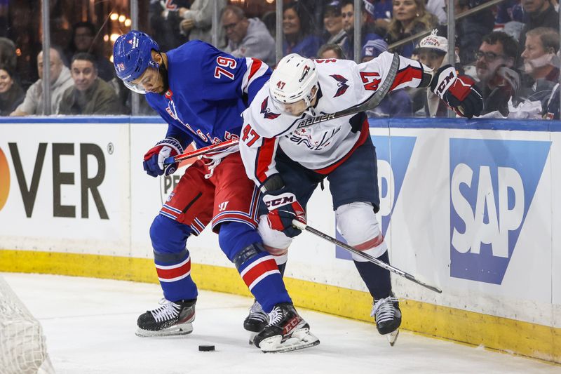 Apr 21, 2024; New York, New York, USA; New York Rangers defenseman K'Andre Miller (79) and Washington Capitals left wing Beck Malenstyn (47) battle for control of the puck in game one of the first round of the 2024 Stanley Cup Playoffs at Madison Square Garden. Mandatory Credit: Wendell Cruz-USA TODAY Sports