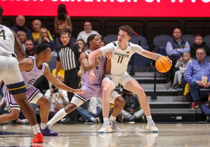 Jan 9, 2024; Morgantown, West Virginia, USA; West Virginia Mountaineers forward Quinn Slazinski (11) backs down against Kansas State Wildcats guard Dai Dai Ames (4) during the first half at WVU Coliseum. Mandatory Credit: Ben Queen-USA TODAY Sports