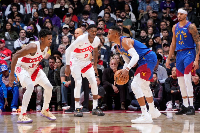 TORONTO, CANADA - OCTOBER 28: DJ Carton #3 and RJ Barrett #9 of the Toronto Raptors defend against the Denver Nuggets on October 28, 2024 at the Scotiabank Arena in Toronto, Ontario, Canada.  NOTE TO USER: User expressly acknowledges and agrees that, by downloading and or using this Photograph, user is consenting to the terms and conditions of the Getty Images License Agreement.  Mandatory Copyright Notice: Copyright 2024 NBAE (Photo by Mark Blinch/NBAE via Getty Images)