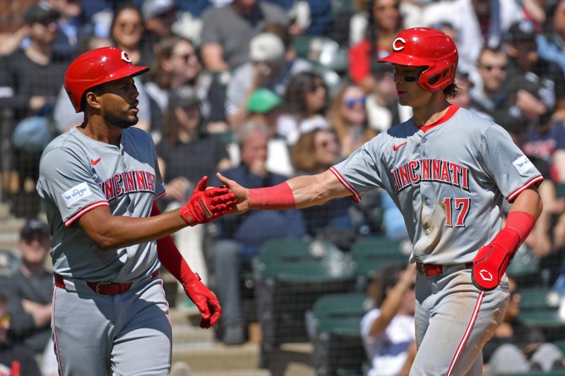 Apr 13, 2024; Chicago, Illinois, USA; Cincinnati Reds third baseman Jeimer Candelario (left) and right fielder Stuart Fairchild (right) celebrate after both scoring during the second inning against the Chicago White Sox at Guaranteed Rate Field. Mandatory Credit: Patrick Gorski-USA TODAY Sports