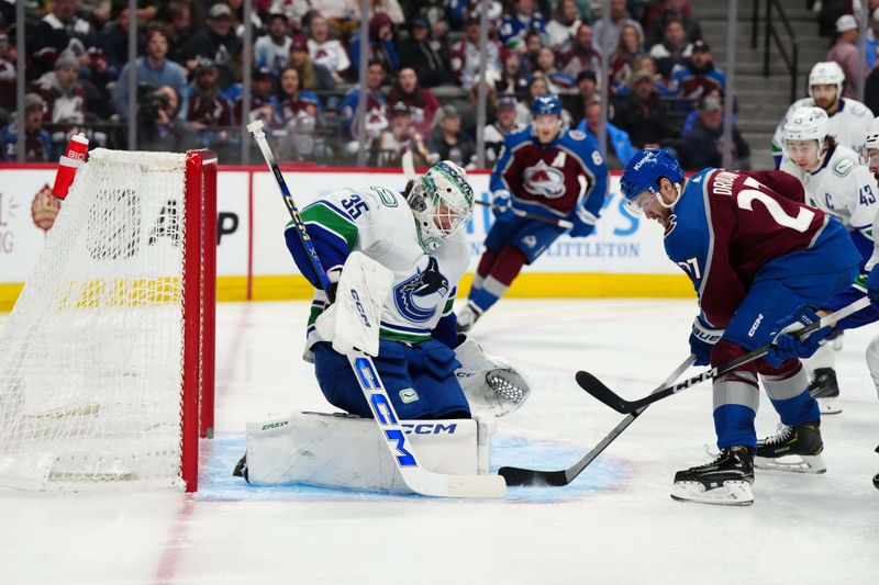 Feb 20, 2024; Denver, Colorado, USA; Vancouver Canucks goaltender Thatcher Demko (35) makes a save on Colorado Avalanche left wing Jonathan Drouin (27) in the second period at Ball Arena. Mandatory Credit: Ron Chenoy-USA TODAY Sports