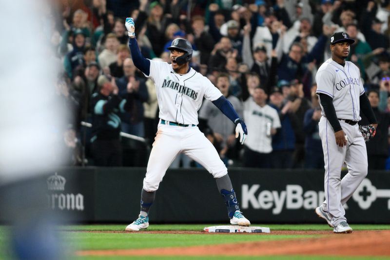 Apr 15, 2023; Seattle, Washington, USA; Seattle Mariners center fielder Julio Rodriguez (44) celebrates at third base after hitting a 3-RBI triple against the Colorado Rockies during the fourth inning at T-Mobile Park. Mandatory Credit: Steven Bisig-USA TODAY Sports