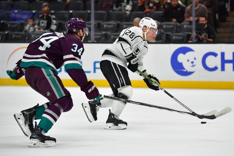 Nov 24, 2023; Anaheim, California, USA; Los Angeles Kings center Jaret Anderson-Dolan (28) moves in for a shot on goal ahead of Anaheim Ducks defenseman Pavel Mintyukov (34) during the first period at Honda Center. Mandatory Credit: Gary A. Vasquez-USA TODAY Sports