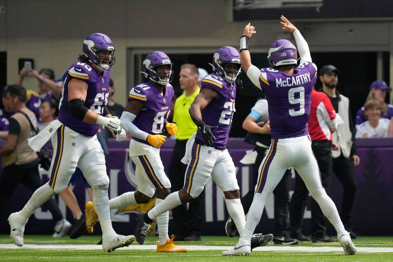 Minnesota Vikings quarterback J.J. McCarthy (9) celebrates with teammates after a touchdown against the Las Vegas Raiders during the first half of an NFL football game Saturday, Aug. 10, 2024, in Minneapolis. (AP Photo/Charlie Neibergall)