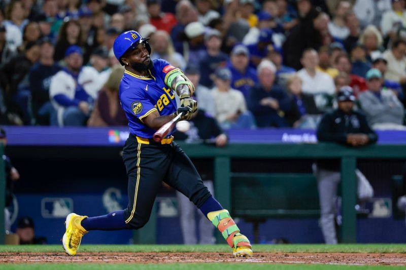 Sep 25, 2025; Seattle, Washington, USA; Seattle Mariners left fielder Randy Arozarena (56) hits a two-run single against the Colorado Rockies during the fourth inning at T-Mobile Park. Mandatory Credit: Joe Nicholson-Imagn Images