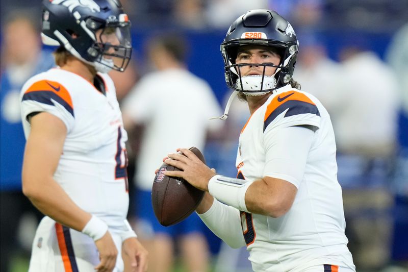 Denver Broncos quarterback Jarrett Stidham (8) warms up before playing against the Indianapolis Colts in a preseason NFL football game, Sunday, Aug. 11, 2024, in Westfield, Ind. (AP Photo/AJ Mast)