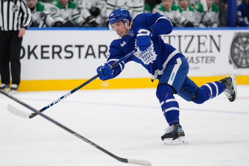 Jan 14, 2025; Toronto, Ontario, CAN; Toronto Maple Leafs forward Mitch Marner (16) shoots the puck against the Dallas Stars during the first period at Scotiabank Arena. Mandatory Credit: John E. Sokolowski-Imagn Images