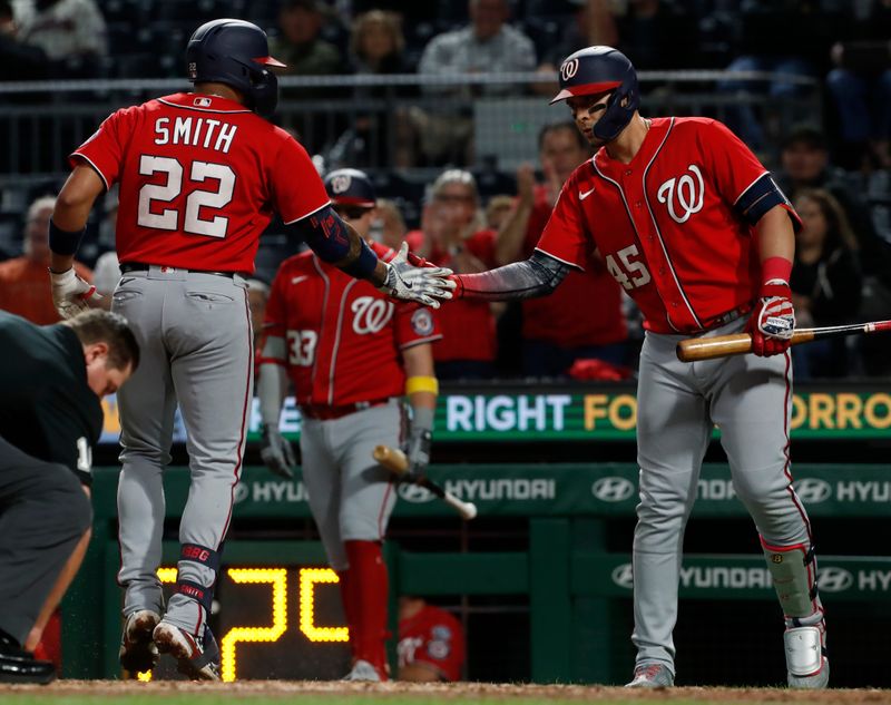 Sep 13, 2023; Pittsburgh, Pennsylvania, USA; Washington Nationals designated hitter Joey Meneses (45) congratulates first baseman Dominic Smith (22) crossing home plate on a two run home run against the Pittsburgh Pirates during the sixth inning at PNC Park. Mandatory Credit: Charles LeClaire-USA TODAY Sports