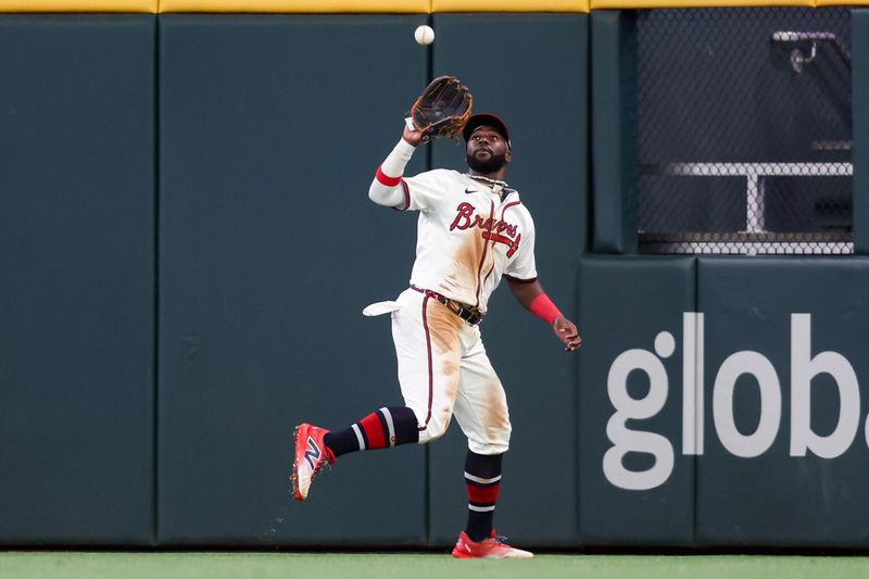 May 8, 2025; Atlanta, Georgia, USA; Atlanta Braves center fielder Michael Harris II (23) catches a fly ball against the Cincinnati Reds in the tenth inning at Truist Park. Mandatory Credit: Brett Davis-Imagn Images
