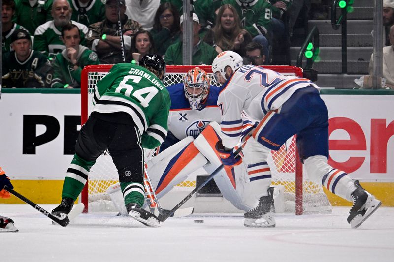 May 21, 2025; Dallas, Texas, USA; Dallas Stars center Mikael Granlund (64) shoots the puck against Edmonton Oilers defenseman Brett Kulak (27) in the first period during game one of the Western Conference Final of the 2025 Stanley Cup Playoffs at American Airlines Center. Mandatory Credit: Jerome Miron-Imagn Images