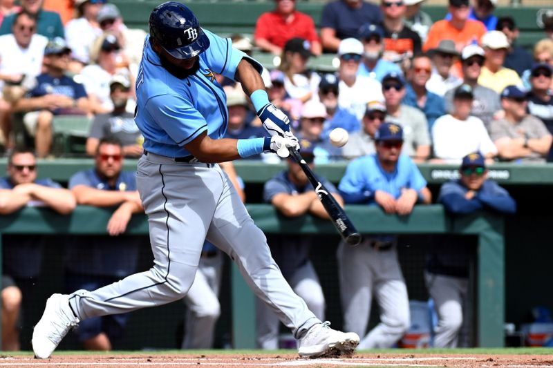 Feb 27, 2023; Sarasota, Florida, USA; Tampa Bay Rays center fielder Manuel Margot (13) hits a single in the first inning of the spring training game against the Baltimore Orioles at Ed Smith Stadium. Mandatory Credit: Jonathan Dyer-USA TODAY Sports