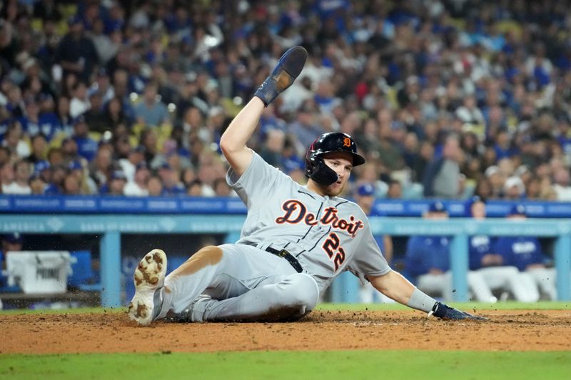 Sep 20, 2023; Los Angeles, California, USA; Detroit Tigers center fielder Parker Meadows (22) slides into home plate to score in the seventh inning against the Los Angeles Dodgers at Dodger Stadium. Mandatory Credit: Kirby Lee-USA TODAY Sports