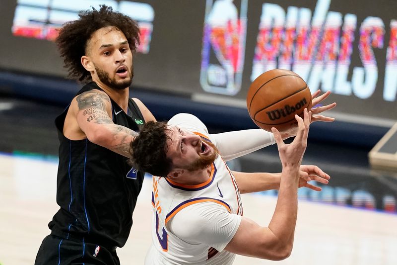 DALLAS, TEXAS - JANUARY 24: Jusuf Nurkic #20 of the Phoenix Suns is fouled by Dereck Lively II #2 of the Dallas Mavericks during the first half at American Airlines Center on January 24, 2024 in Dallas, Texas. NOTE TO USER: User expressly acknowledges and agrees that, by downloading and or using this photograph, User is consenting to the terms and conditions of the Getty Images License Agreement. (Photo by Sam Hodde/Getty Images)