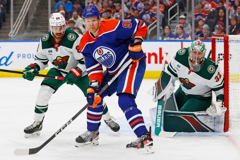 Feb 23, 2024; Edmonton, Alberta, CAN; Edmonton Oilers forward Corey Perry (90) looks for a pass in front of Minnesota Wild goaltender Filip Gustavsson (32) during the first period at Rogers Place. Mandatory Credit: Perry Nelson-USA TODAY Sports