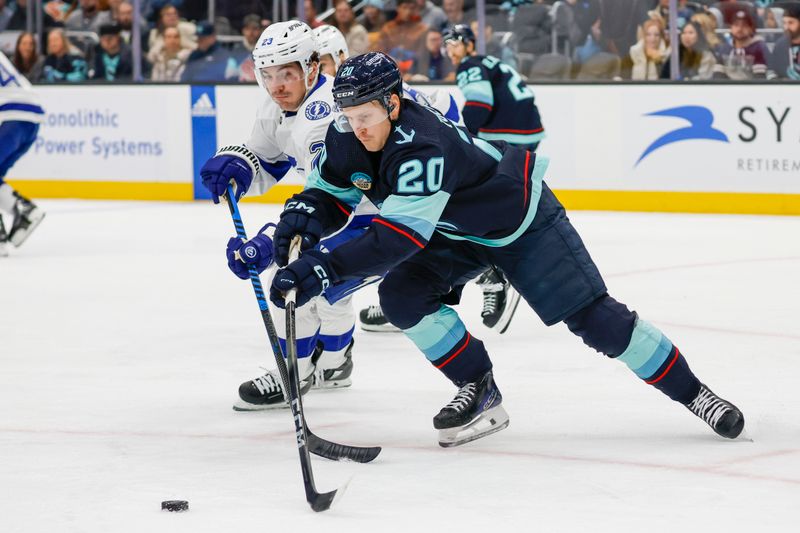 Dec 9, 2023; Seattle, Washington, USA; Seattle Kraken right wing Eeli Tolvanen (20) skates with the puck against the Tampa Bay Lightning during the first period at Climate Pledge Arena. Mandatory Credit: Joe Nicholson-USA TODAY Sports