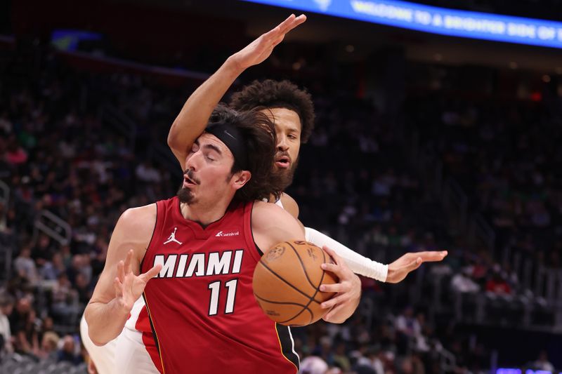 DETROIT, MICHIGAN - MARCH 17: Jaime Jaquez Jr. #11 of the Miami Heat tries to drive around Cade Cunningham #2 of the Detroit Pistons during the first half at Little Caesars Arena on March 17, 2024 in Detroit, Michigan. NOTE TO USER: User expressly acknowledges and agrees that, by downloading and or using this photograph, User is consenting to the terms and conditions of the Getty Images License.  (Photo by Gregory Shamus/Getty Images)