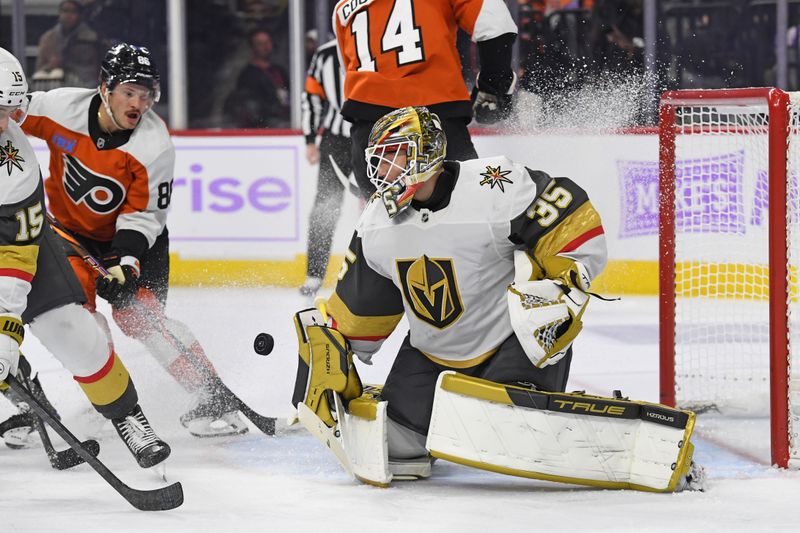 Nov 25, 2024; Philadelphia, Pennsylvania, USA; Philadelphia Flyers goaltender Aleksei Kolosov (35) makes a save as Philadelphia Flyers left wing Joel Farabee (86) looks for the rebound during the third period at Wells Fargo Center. Mandatory Credit: Eric Hartline-Imagn Images