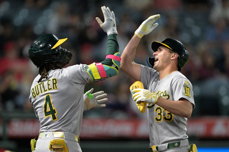 Jun 9, 2025; Anaheim, California, USA;    Athletics center fielder JJ Bleday (33) celebrates a two run home run with right fielder Lawrence Bulter (4) in the eighth inning against the Los Angeles Angels at Angel Stadium. Mandatory Credit: Jayne Kamin-Oncea-Imagn Images