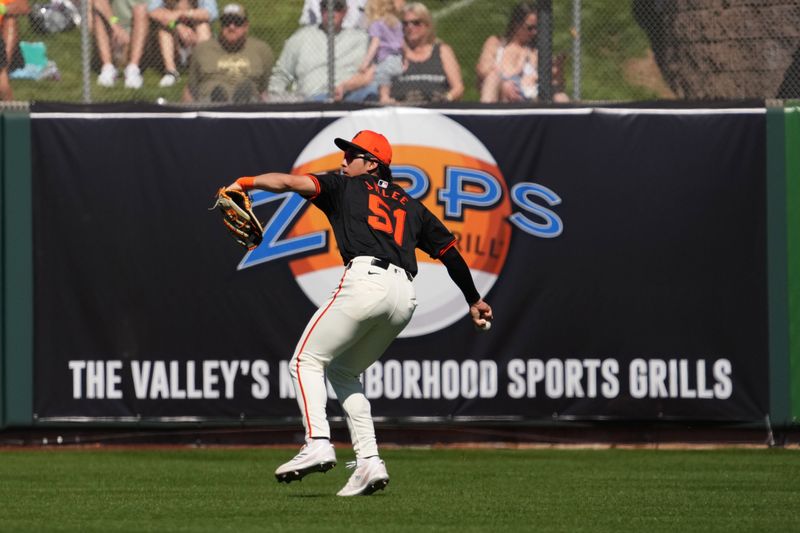 Mar 1, 2024; Scottsdale, Arizona, USA; San Francisco Giants outfielder Jung Hoo Lee (51) throws the ball against the Texas Rangers during the second inning at Scottsdale Stadium. Mandatory Credit: Joe Camporeale-USA TODAY Sports