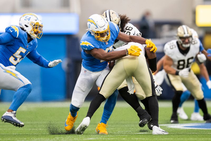 Los Angeles Chargers linebacker Daiyan Henley (0) tackles New Orleans Saints quarterback Jameis Winston (2) during an NFL preseason football game, Sunday, Aug. 20, 2023, in Inglewood, Calif. (AP Photo/Kyusung Gong)