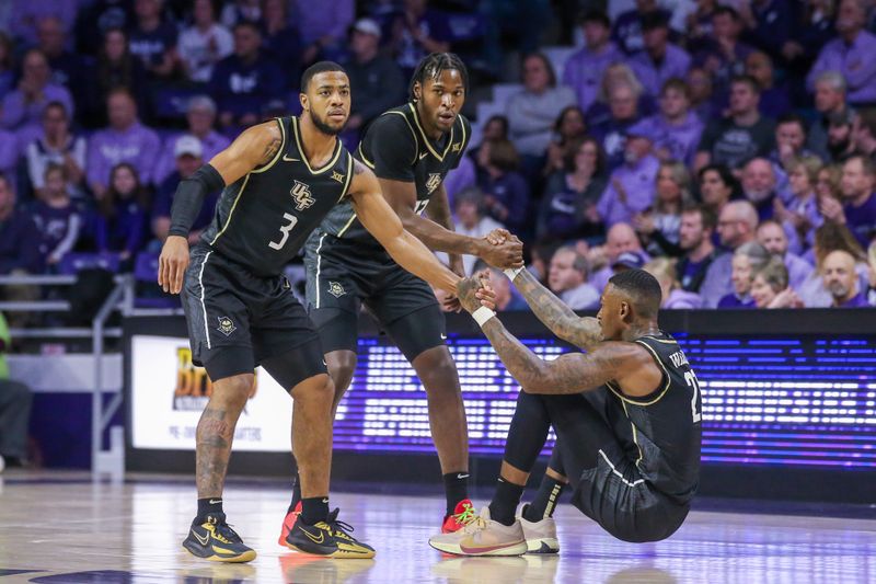 Jan 6, 2024; Manhattan, Kansas, USA; UCF Knights guard Darius Johnson (3) and forward Marchelus Avery (13 help guard C.J. Walker (21) off the floor during the first half against the Kansas State Wildcats at Bramlage Coliseum. Mandatory Credit: Scott Sewell-USA TODAY Sports