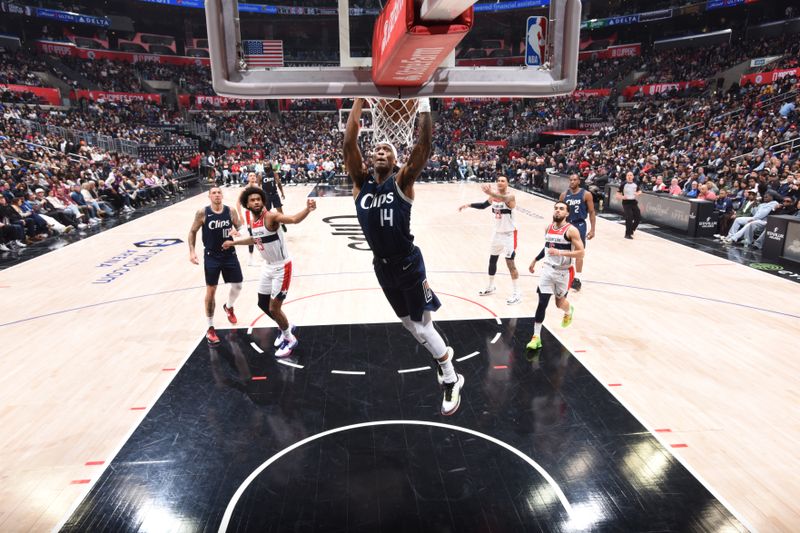 LOS ANGELES, CA - MARCH 1: Terance Mann #14 of the LA Clippers dunks the ball during the game against the Washington Wizards on March 1, 2024 at Crypto.Com Arena in Los Angeles, California. NOTE TO USER: User expressly acknowledges and agrees that, by downloading and/or using this Photograph, user is consenting to the terms and conditions of the Getty Images License Agreement. Mandatory Copyright Notice: Copyright 2024 NBAE (Photo by Adam Pantozzi/NBAE via Getty Images)