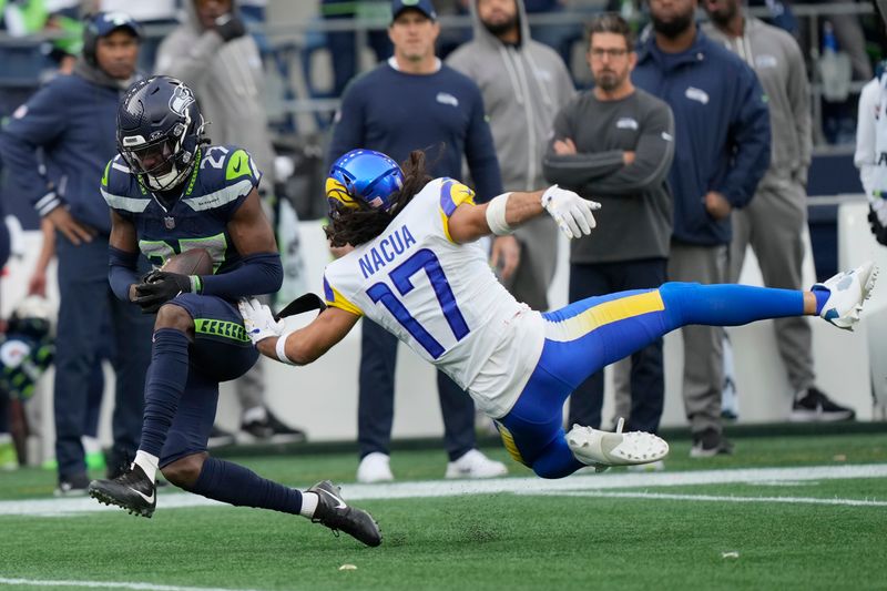 Seattle Seahawks cornerback Riq Woolen, left, intercepts a pass intended for Los Angeles Rams wide receiver Puka Nacua (17) during the first half of an NFL football game in Seattle, Sunday, Nov. 3, 2024. (AP Photo/Stephen Brashear)