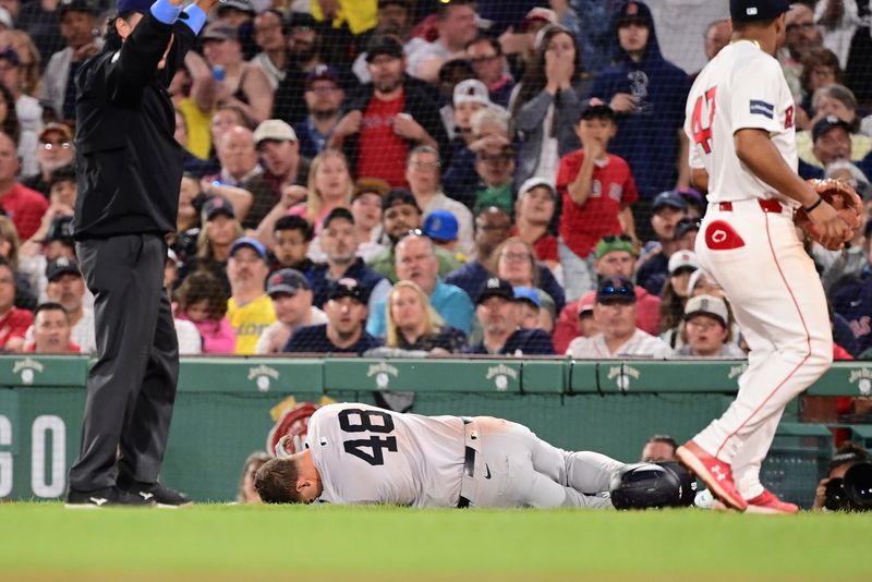 Jun 16, 2024; Boston, Massachusetts, USA; New York Yankees first baseman Anthony Rizzo (48) trips on Boston Red Sox pitcher Brennan Bernardino (not pictured) and rolls on the ground during the seventh inning at Fenway Park. Mandatory Credit: Eric Canha-USA TODAY Sports