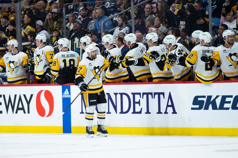 Feb 10, 2024; Winnipeg, Manitoba, CAN;  Pittsburgh Penguins forward Bryan Rust (17) is congratulated by his team mates on his goal against the Winnipeg Jets during the second period at Canada Life Centre. Mandatory Credit: Terrence Lee-USA TODAY Sports