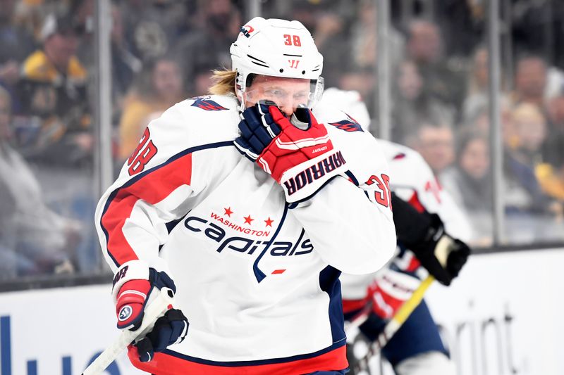 Oct 3, 2023; Boston, Massachusetts, USA;  Washington Capitals defenseman Rasmus Sandin (38) holds his mouth after getting a high stick during the first period against the Boston Bruins at TD Garden. Mandatory Credit: Bob DeChiara-USA TODAY Sports